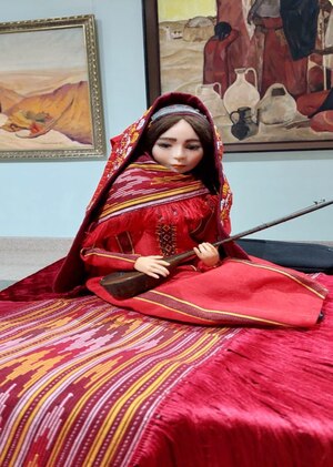 The author's doll in a Turkmen costume "Girl with a dutar"
