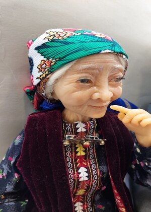 The author's doll in a Turkmen costume "Ene - grandma"